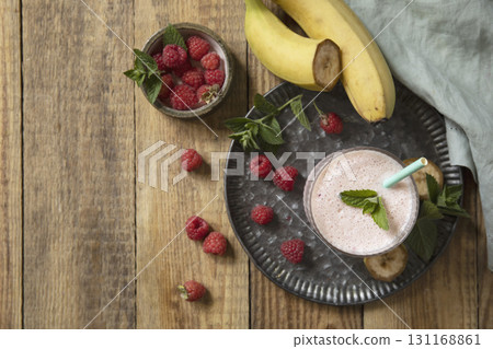 Refreshing banana raspberry smoothie with fresh mint for healthy living and summer enjoyment. 131168861