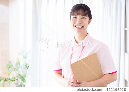 Caregiver with file Caregiver with file 131168928