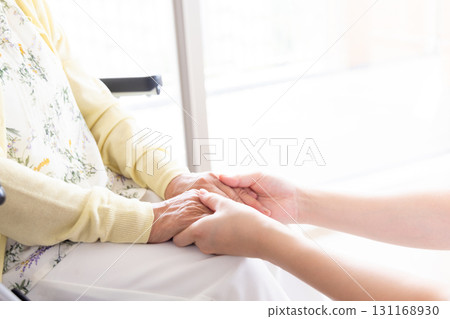 Woman holding senior woman's hand Woman holding senior woman's hand 131168930