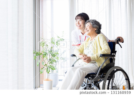 Senior woman in wheelchair and young caregiver 131168939