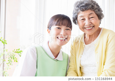Senior woman and young caregiver 131168944