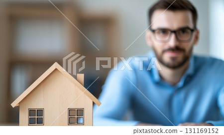 financial advisor discussing property investment with model house. advisor is focused and professional, emphasizing importance of real estate 131169152