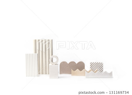 A collection of various abstract, minimalist geometric shapes made of natural materials and neutral colors, arranged on a pure white background. 131169734