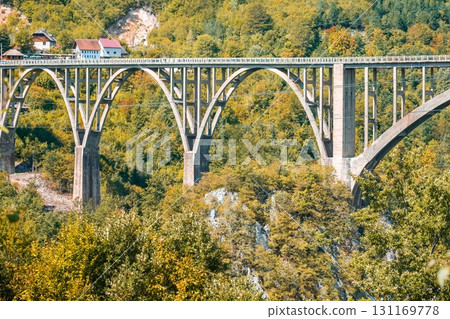 Stone bridge in Durmitor National Park Montenegro with autumn forest. 131169778