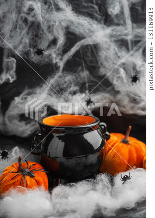 Halloween Cauldron with Pumpkins, Spiders and Cobwebs 131169913