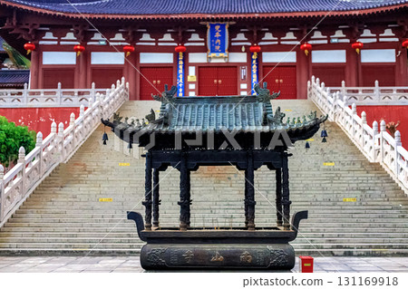 Hainan Island, Sanya: Nanshan Buddhist Center. View of the incense burner in front of the Temple Hainan Island, Sanya: Nanshan Buddhist Center. View of the incense burner in front of the Temple 131169918