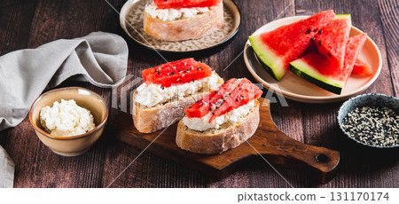 Delicious sandwich with ricotta, watermelon and sesame seeds on a board on the table web banner Delicious sandwich with ricotta, watermelon and sesame seeds on a board on the table web banner 131170174