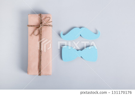 Mustache health concept, gift, paper mustache and butterfly on blue background 131170176