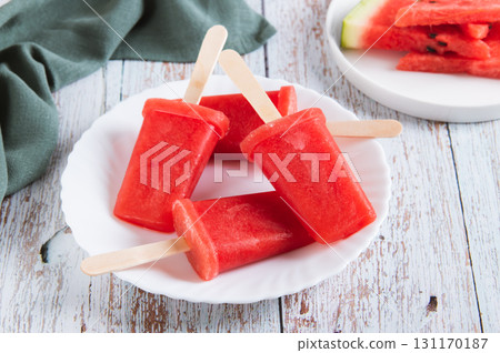 Red watermelon popsicle ice cream on a plate on the table 131170187