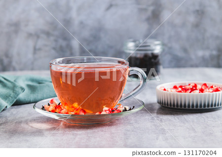 Detox green pomegranate tea in a cup on the table Detox green pomegranate tea in a cup on the table 131170204