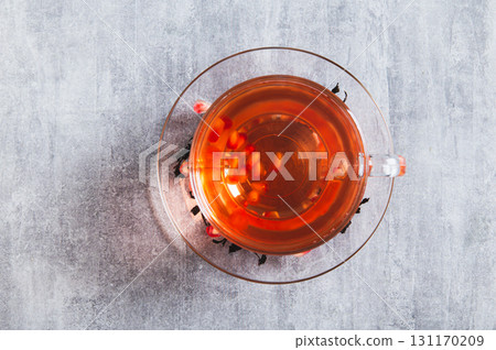 Close up of detox green pomegranate tea in a cup on the table top view 131170209