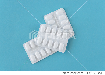 Much medical pills and drugs in white plastic package on the blue background. Healthcare concept. 131170351