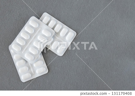 Much medical pills and drugs in white plastic package on the gray background. Healthcare concept. Space for text. Much medical pills and drugs in white plastic package on the gray background. Healthcare concept. Space for text. 131170408