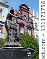 bronze statue of Tryton fountain in Gdansk Poland pigeon bird on head 131171758