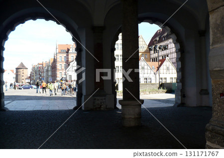 Old town square buildings lit by the sun Gdansk, Poland three archways 131171767