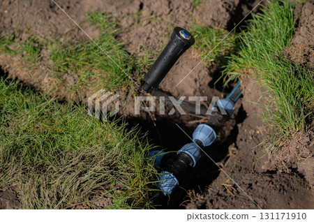 The complete installation of an irrigation system in a garden to enhance plant growth 131171910