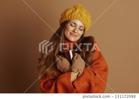 Woman Holding Mug to Chest with Closed Eyes Woman Holding Mug to Chest with Closed Eyes 131172098
