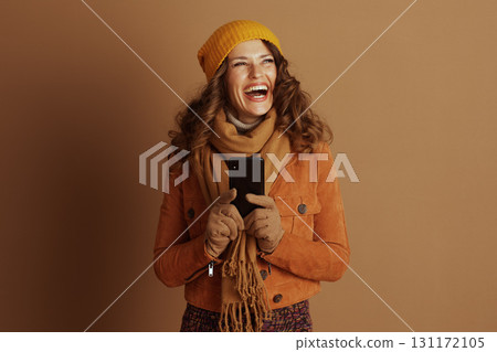 Joyful Woman Laughing while Using a Smartphone 131172105
