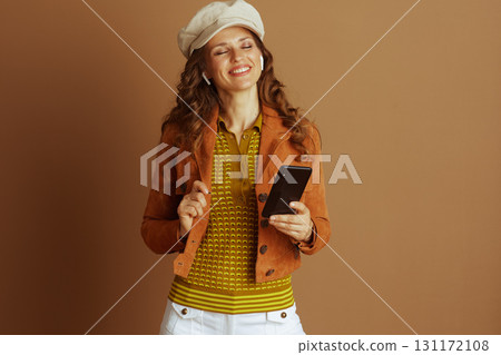 Woman Enjoying Audio on Smartphone in Autumn Style 131172108