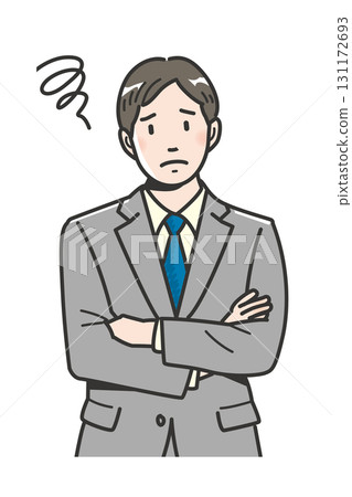 The upper body of a worried young businessman with his arms crossed 131172693