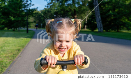 Toddler on scooter. Yellow scooter ride girl. Child park activity summer. Toddler on scooter. Yellow scooter ride girl. Child park activity summer. 131173610