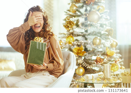 Woman Hiding Eyes, Ready for Christmas Surprise Woman Hiding Eyes, Ready for Christmas Surprise 131173641
