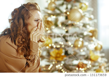 Emotional Holiday Moment by Christmas Tree 131173659