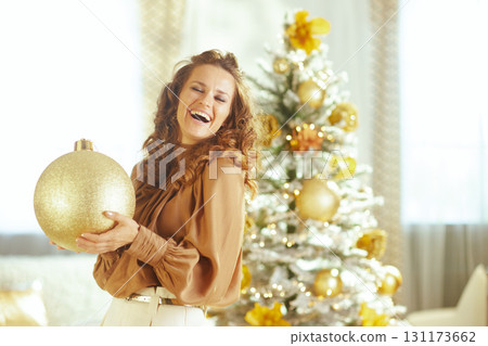 Laughing Woman in Silk Blouse Decorates Tree Laughing Woman in Silk Blouse Decorates Tree 131173662