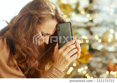 Reflective Woman with Phone During Holidays 131173723