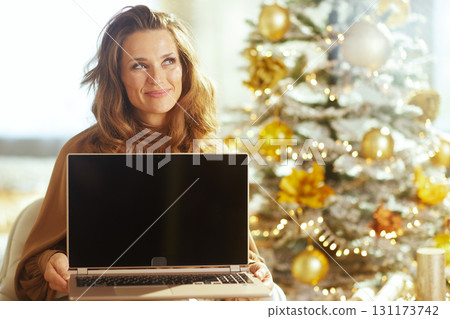 Woman Using Laptop in Festive Christmas Setting Woman Using Laptop in Festive Christmas Setting 131173742