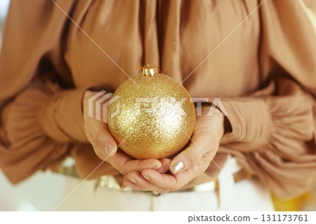 Sparkly Gold Ornament in Cupped Hands 131173761