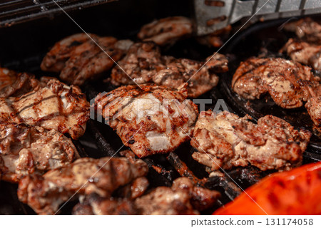 Grilled chicken and red peppers on barbecue grill Grilled chicken and red peppers on barbecue grill 131174058