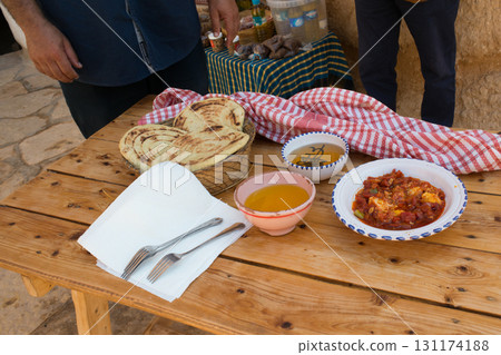 Assorted bereber food on a table, flatbread, olive oil, honey and vegetables Assorted bereber food on a table, flatbread, olive oil, honey and vegetables 131174188