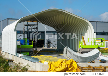 Pre-engineered commercial metal storage building under assembly at industrial construction site 131174605