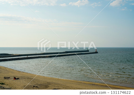 Baltic Sea coastline with breakwaters and lighthouses in Pavilosta, Latvia on a sunny day Baltic Sea coastline with breakwaters and lighthouses in Pavilosta, Latvia on a sunny day 131174622