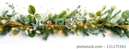 Festive garland with pinecones and eucalyptus accented by string lights and dusting of snow 131175363