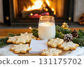 Cozy fireplace, milk, and star-shaped cookies for a warm holiday evening 131175702