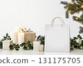 Elegant holiday gift arrangement with holly, candles, and festive decorations 131175705