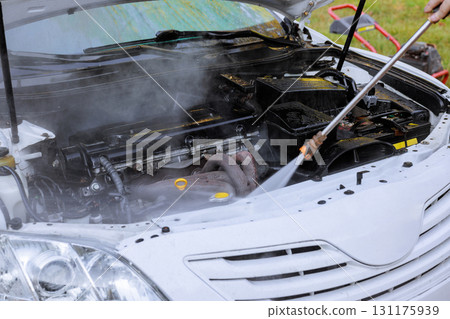 Cleaning car engine with steam for better maintenance performance. Cleaning car engine with steam for better maintenance performance. 131175939