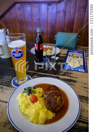 Traditional Bavarian meal with mashed potatoes, meat patties, and beer in a restaurant in Munich, Germany Traditional Bavarian meal with mashed potatoes, meat patties, and beer in a restaurant in Munich, Germany 131175980