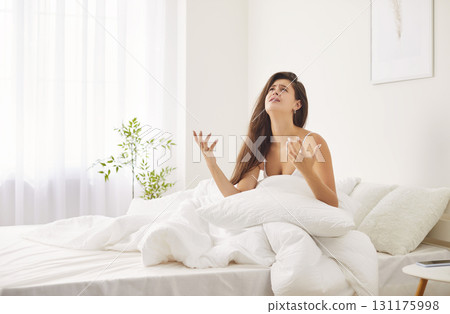 Annoyed young woman in bed suffers from noise having sleepless night, noisy neighbors, angry girl Annoyed young woman in bed suffers from noise having sleepless night, noisy neighbors, angry girl 131175998