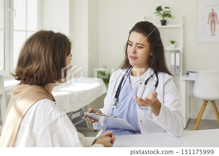 Doctor Or Nurse Consulting A Patient In A Hospital Office 131175999