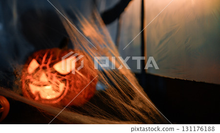 Halloween Pumpkin And Scary Cobwebs In Front Of A Window 131176188