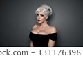 Half-length portrait of attractive curvy platinum blonde caucasian woman in tight black off-the-shoulder top looking at camera indoor on dark grey background with copy space. Digital art illustration. 131176398