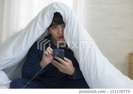 Man hiding under the futon 131176779