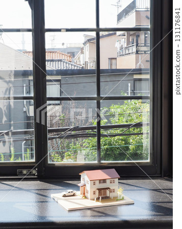 A model house placed in a bay window A model house placed in a bay window 131176841