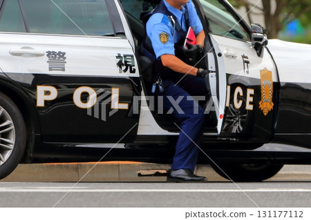Patrol car and police officer Patrol car and police officer 131177112