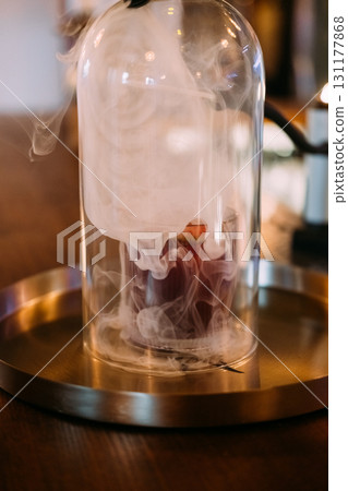 Cocktail smoke. Serving drink. Glass cloche with aroma beverage in swirling fume cloud. Pub modern technique presenting alcoholic liquid. 131177868