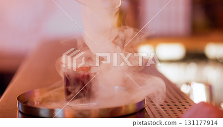 Cocktail smoke defocused. Serving drink. Glass with aroma beverage in swirling fume cloud. Pub modern technique presenting alcohol. Cocktail smoke defocused. Serving drink. Glass with aroma beverage in swirling fume cloud. Pub modern technique presenting alcohol. 131177914