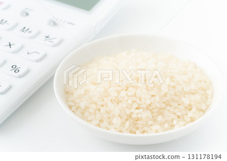 Close-up of a calculator and a plate of white rice 131178194